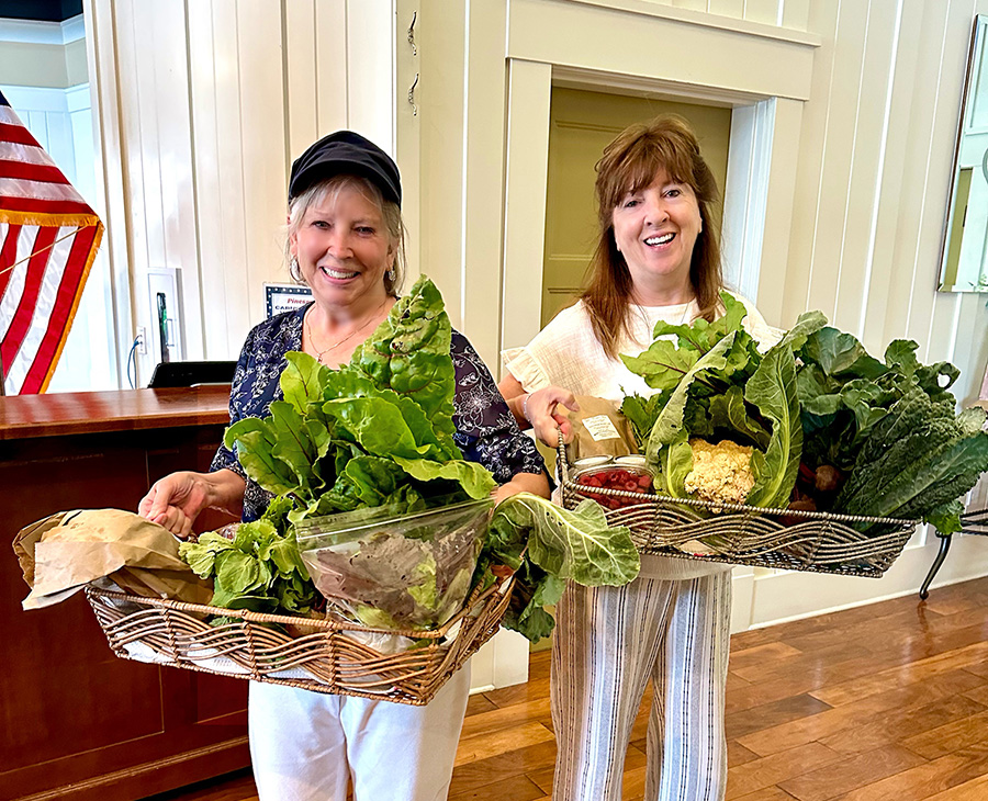 June 20, 2024 – Door Prize Winners: Congratulations to our June door prize winners (L to R) Ronna Achter and Denise Pace! They were delighted to receive gift certificates and fresh garden vegetables from Table Meadows Farm. Photo credit: Nancy Lichtle.  (Photo Credit: Nancy Lichtle)