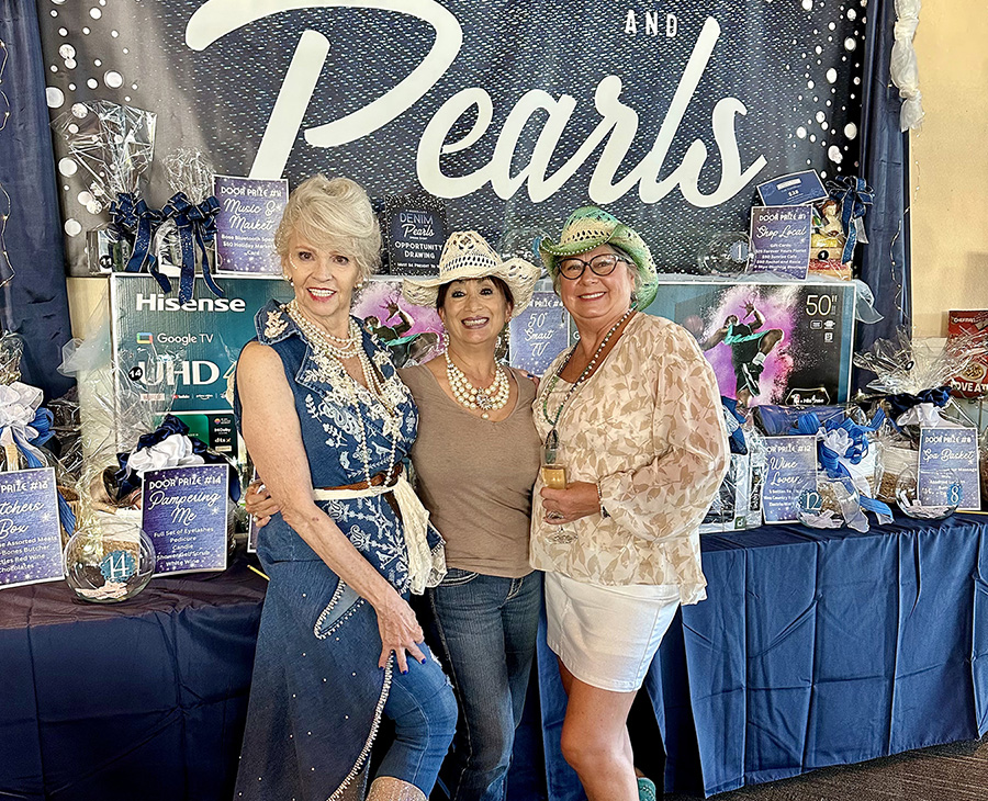 April 20, 2024 – Denim & Pearls Spring Event brought big smiles at the “opportunity draw table” from (L to R) Kathleen Medley-Lewis, Pamela Archuleta and Donna Cloud.  (Photo Credit: Nancy Lichtle)